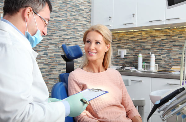 Woman talking to dentist during dental exam, at Ortega Dental in Jacksonville, FL.